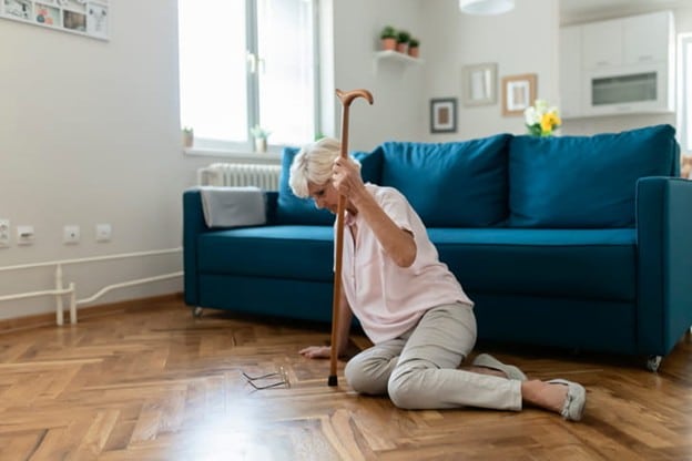 An Elderly Woman On The Floor After Falling.
