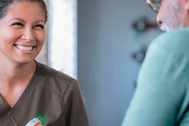 Skilled nurse helping patient with medication