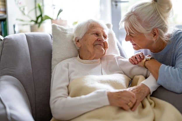A Daughter Smiles At Her Elderly Mother.