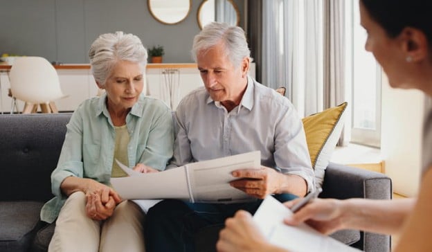An Elderly Couple Reviews Important Documents Together.